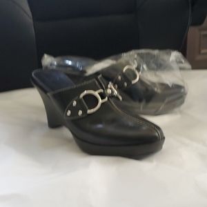 Gently used black leather clogs.